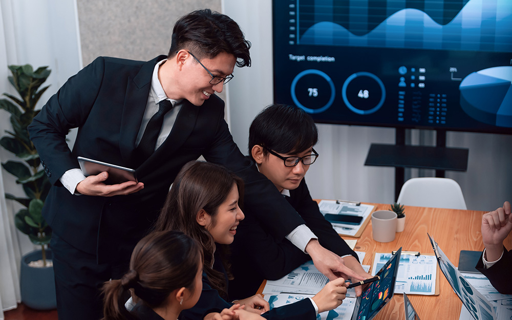 Business team of financial data analysis meeting report paper in harmony office